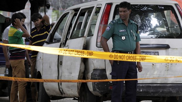 Bangladeshi police at the site where Italian citizen Cesare Tavella was gunned down by unidentified assailants in Dhaka last year. 