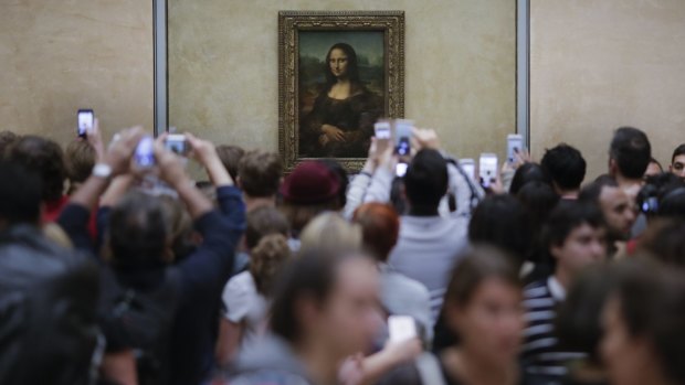 Visitors crowded in front of Leonardo da Vinci's painting 'Mona Lisa' at the Louvre. 