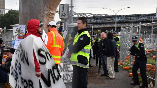 Police speak to protesters at the Parkville tree protest on Tuesday.