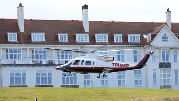 Trump arrival: Reporters were limited to questions about golf while Trump was at his golf course in Scotland on Friday. 