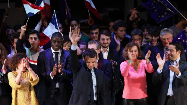 Emmanuel Macron, centre, was in London to raise his international profile, court expatriates and meet with Prime Minister Theresa May before a fundraising dinner.