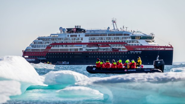 Roald Amundsen passengers weave their way between icebergs.
