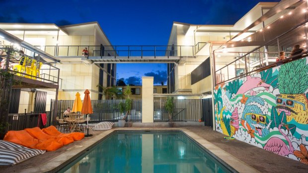 The solar-heated swimming pool with beanbag sun-loungers – and  mural   by Sydney street-artist Mulga.