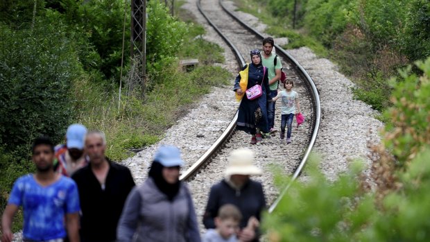 Migrants from Syria walk in Macedonia, near the Greek border, on Wednesday. Tens of thousands of migrants enter Europe through the Balkans from the Middle East and Africa.  