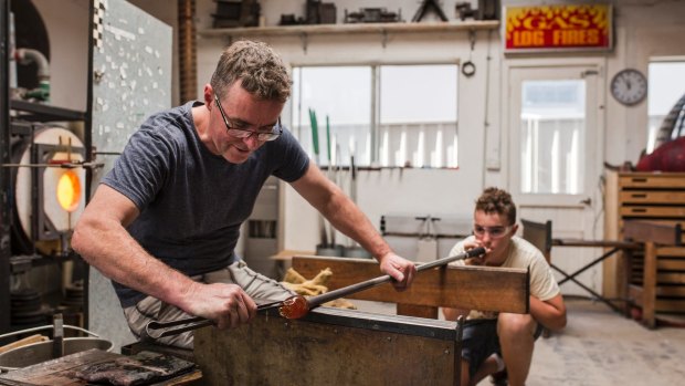 Glass artist Matt Curtis teaches his son Hugo Curtis his craft at Curtis Glass Art Studio.