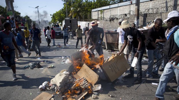 Demonstrators burn debris during a protest against official election results in Port-au-Prince, Haiti, on Tuesday.