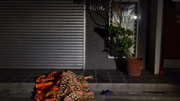 A person killed by masked men lies in the street in Manila, part of President Rodrigo Duterte's drug crackdown. 