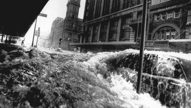 Don't be the person who drives his car into floodwaters. This image was taken in 1972 as flash flooding hit Elizabeth Street.