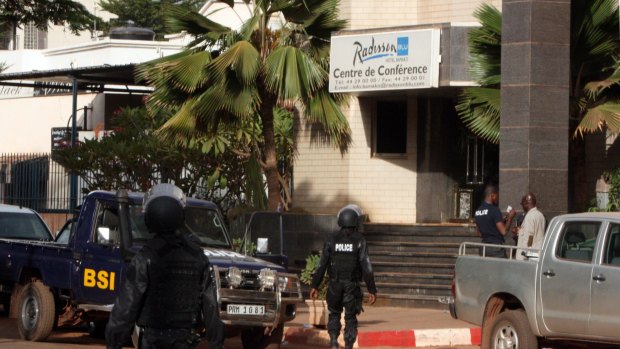 Mali police walk outside an entrance to the Radisson Blu hotel's conference centre after the terrorist attack on Friday. 