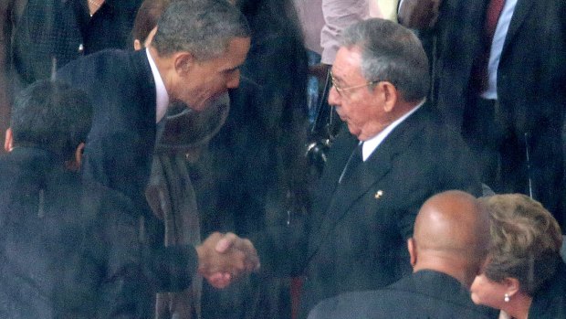 President Barack Obama shakes hands with Cuban President Raul Castro during the official memorial service for former South African President Nelson Mandela in Johannesburg, South Africa, in 2013.