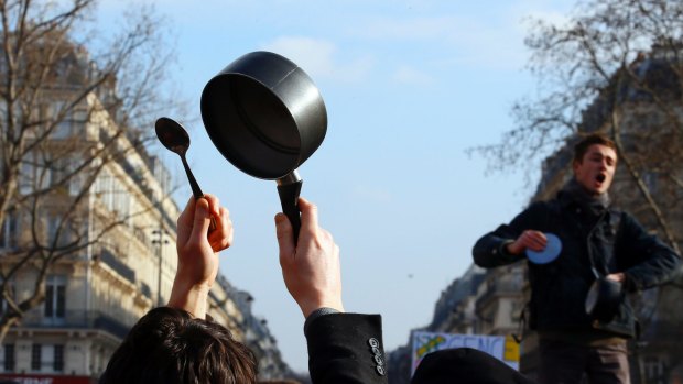 Activists from left-wing parties and other groups beat with spoon on saucepan during one of the demonstrations against corruption at the Place de la Republique.