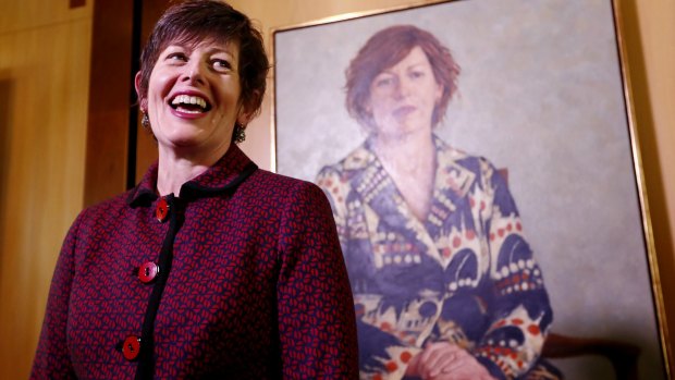 Former speaker Anna Burke stands before her portrait, painted by Jude Rae, at Parliament House in Canberra on Thursday.