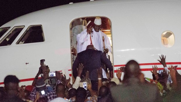 Yahya Jammeh's supporters watch as he enters the plane taking him from Gambia, where he has ruled since 1994.  