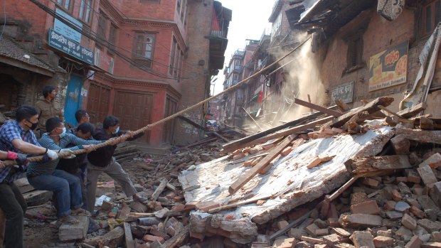 An unstable building is demolished with ropes on a main road in Bhaktapur, Nepal. 
