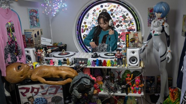 Cosplaykoechan, a Cosplay DJ, practices  in her capsule room.