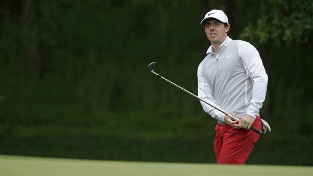 Rory McIlroy watches his chip shot on the 12th hole during the first round of the Wells Fargo Championship golf tournament.