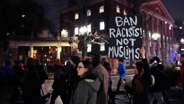 Several hundred people march through Harvard University while protesting the travel ban. 