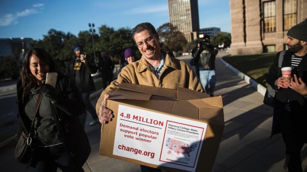 Daniel Brezenoff, who started a Change.org petition demanding electors support the popular vote winner, arrives to deliver a box containing signatures to the office of the Texas Secretary of State.