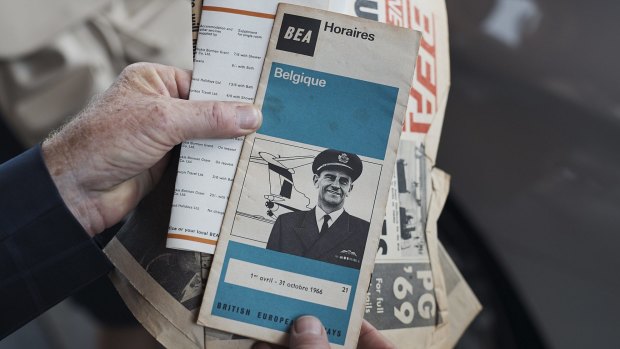Frank Dell examines a vintage British Airways flight schedule, featuring an image of himself.