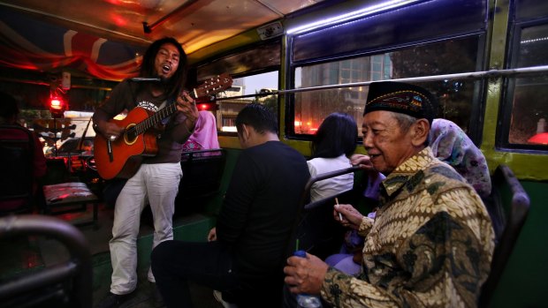 'Ho' entertains commuters on a bus.