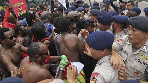 Papuan activists scuffle with police officers during a rally marking the 53rd anniversary of the Free Papua Movement in Jakarta in December 2014