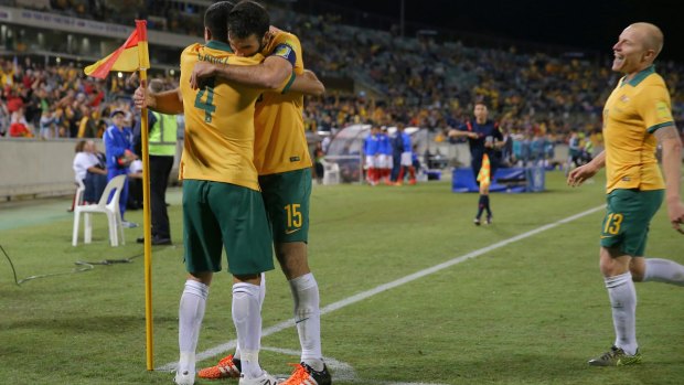 Tim Cahill is embraced by Mile Jedinak after scoring to put Australia 2-0 ahead.