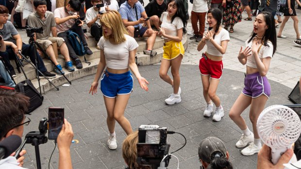 Young Korean women dance to K-Pop in Hongdae, a hip district popular with students.