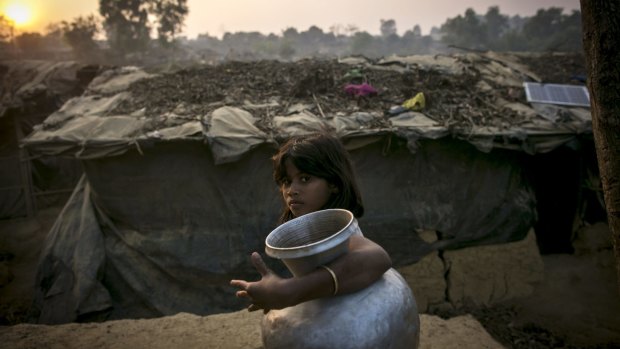 A girl carries a water jug in Kutapalong Rohingya refugee camp in Cox's Bazar, Bangladesh. 
