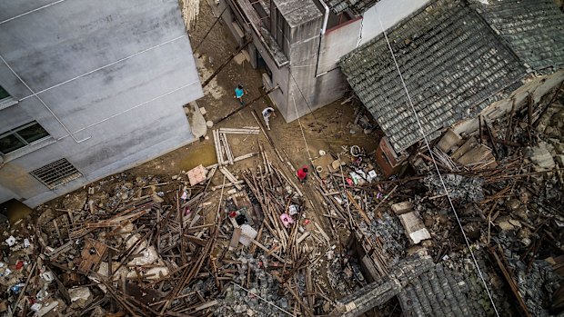 A birds eye view of residents walking past the damaged stores in the aftermath.