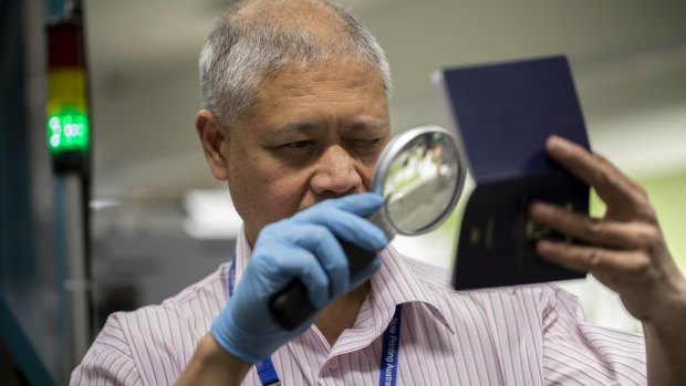 An Australian passport undergoes a quality check at Note Printing Australia Limited.