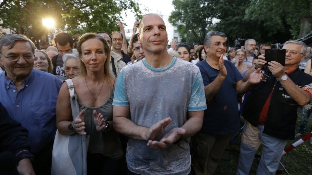 Greece's Finance Minister Yanis Varoufakis, centre, a dual Australian-Greek citizen, and his wife Danae Stratou applaud musicians during a concert at the state broadcaster ERT  following its re-launch on Thursday.