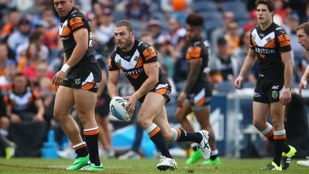 The unhappy hooker: Robbie Farah runs the ball during Wests Tigers' clash with the Warriors. Farah is fuming after being told to look elsewhere in 2016.
