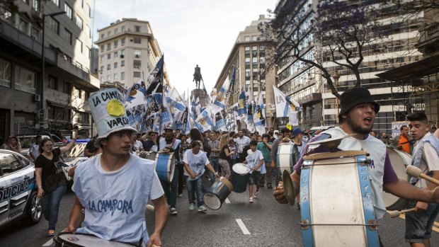Supporters play musical instruments while waiting for the final polling results in Plaza de Mayo Square, near the campaign headquarters of presidential candidate Daniel Scioli in Buenos Aires on Sunday.