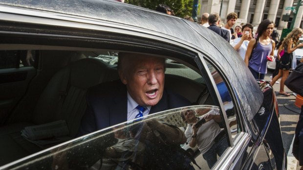 Donald Trump departs jury duty in a limousine.