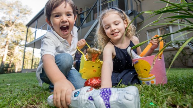 Jack and Charlotte Post fill their baskets on an early Easter Egg hunt in Sydney.
