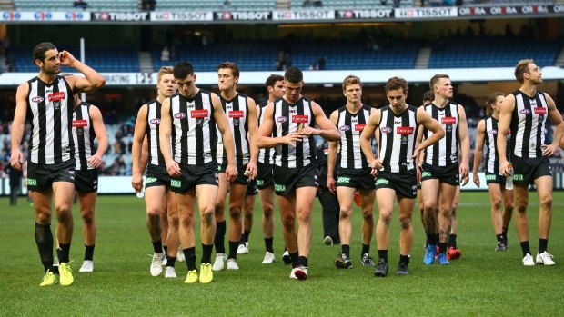 The defeated Magpies walk off the ground but coach Nathan Buckley still hopes for finals.