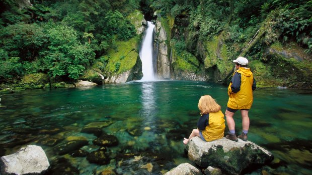 Two hikers relaxing at Giant's Gates Falls.