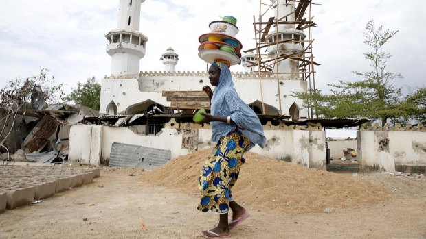 A girl walks past a destroyed mosque in the town of Mararaba, after the Nigerian military recaptured it from Boko Haram this month.