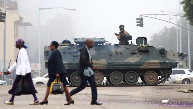An armed soldier patrols a street in Harare, Zimbabwe on Wednesday.