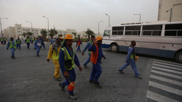 Workers at Al Rayyan Stadium in Doha, Qatar. 