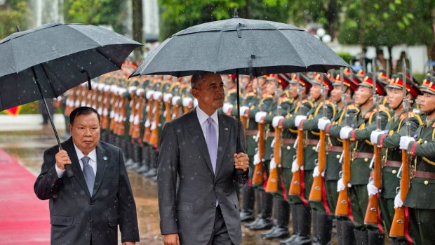 Laotian President Bounnhang Vorachit, left, and US President Barack Obama inspect an honour guard at the Presidential Palace in Vientiane, Laos.
