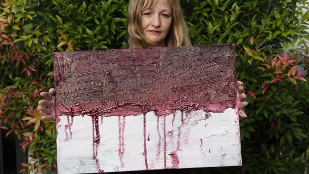 Tina Bailey, Sukumaran's painting teacher, holds a stark painting of the Indonesian flag created in the lead up to his execution.