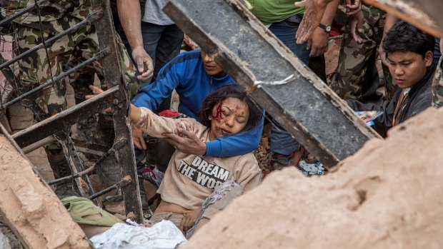 Emergency rescue workers find a survivor in the debris of Dharara tower after it collapsed on April 25, 2015 in Kathmandu.