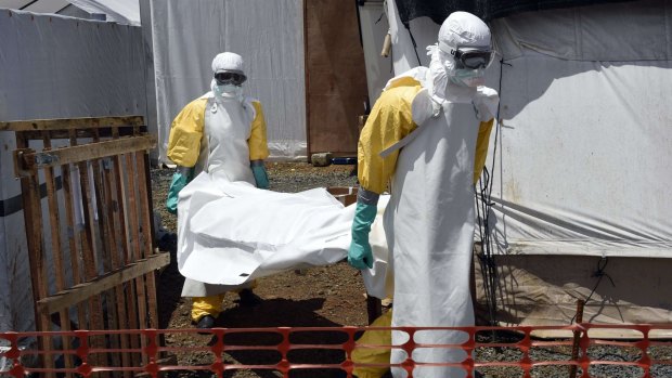 Medical staff carrying the body of an Ebola victim in Monrovia, Liberia, in September last year. 