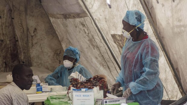 Health workers take blood samples in Sierra Leone in June last year.