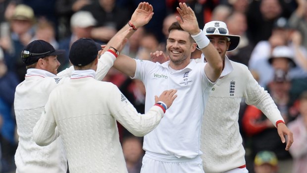 On fire ... England's James Anderson is congratulated after bowling Australia's Peter Nevill out for a duck. He ended the day with 6-47.
