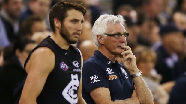 Dale Thomas and Blues coach Mick Malthouse look on during the game.