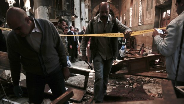 Security forces examine the scene inside the St Mark Cathedral in central Cairo.