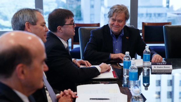 Steve Bannon, right, campaign CEO for Republican presidential candidate Donald Trump, looks on during a national security meeting with advisers.