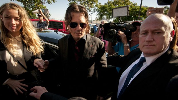 Dog of a day: Johnny Depp and Amber Heard at Southport Courthouse on Monday morning. 